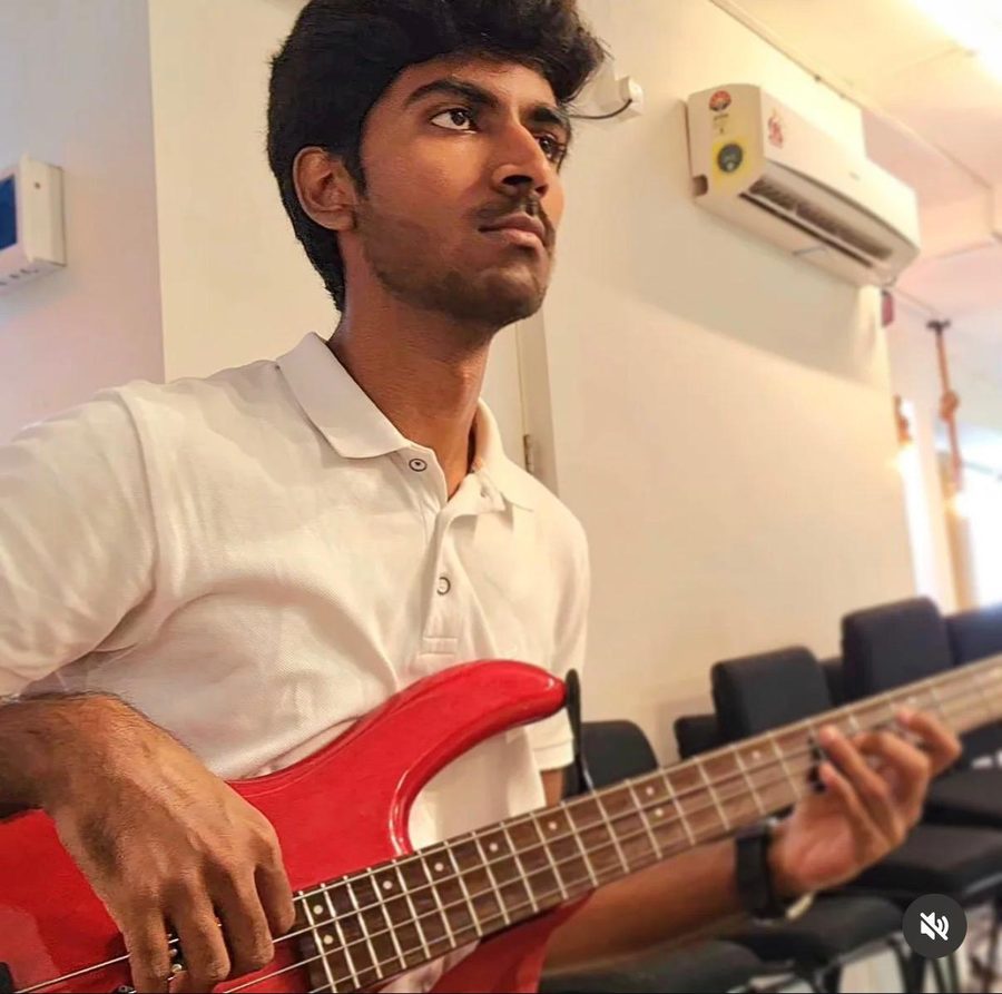 Playing a red bass guitar